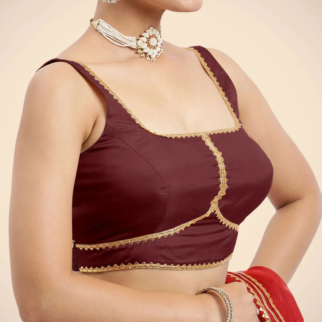 Arya x Tyohaar | Burgundy Sleeveless FlexiFit™ Saree Blouse with Square Neck and Back Window Embeliished with Golden Gota and Pearl Lace